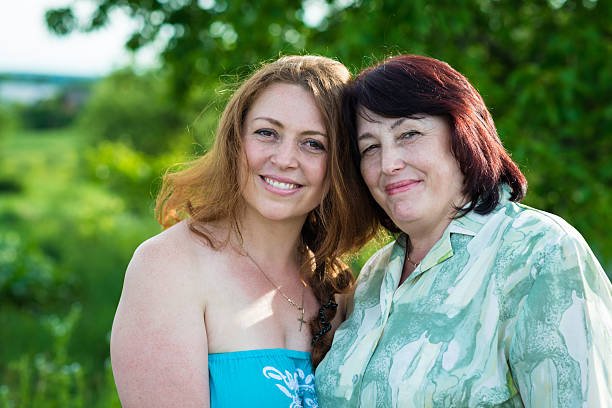 smiling mother and daughter in the garden